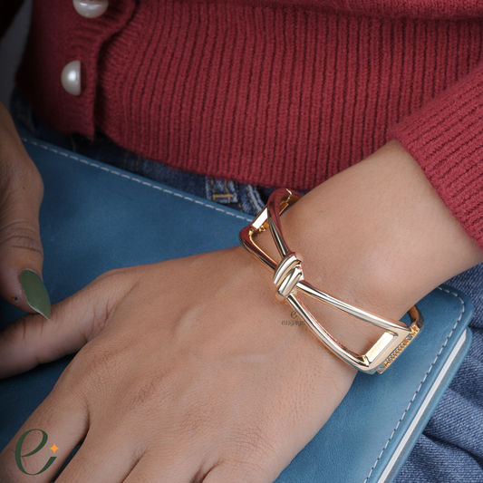 Gold bracelet on a wrist with a red sweater